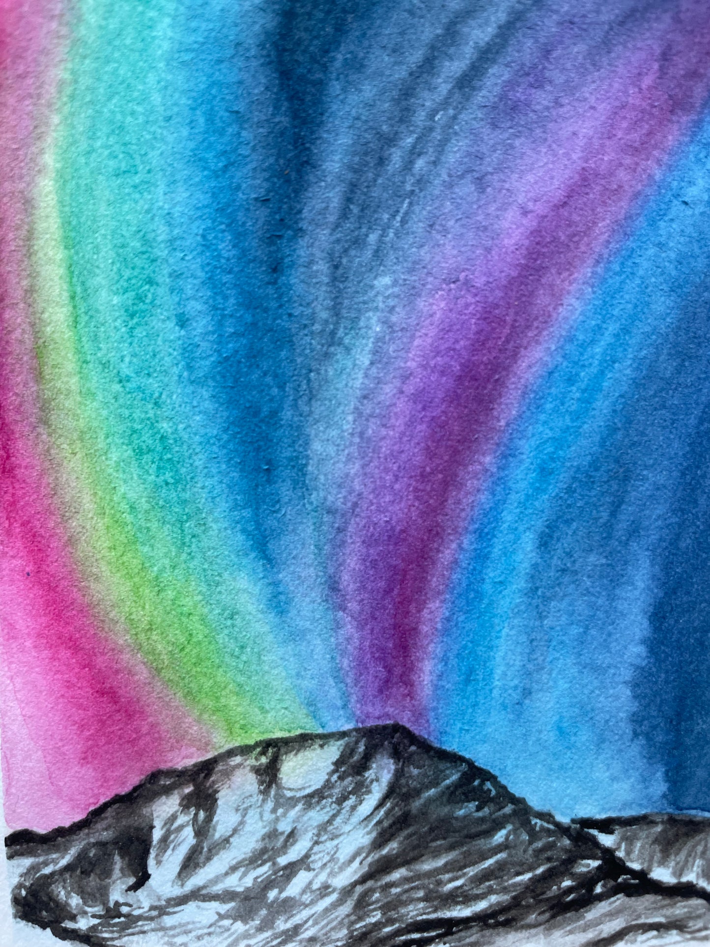 Pink, green, blue, and purple aurora with black and white mountain