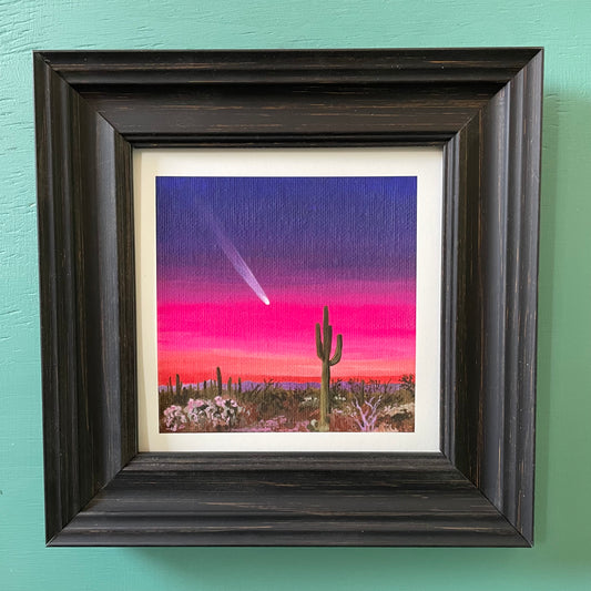 Print of comet painting in a black frame