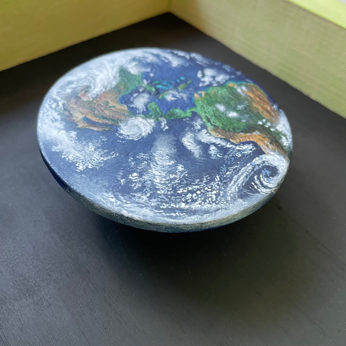 Close up of Earth painting floating in the frame