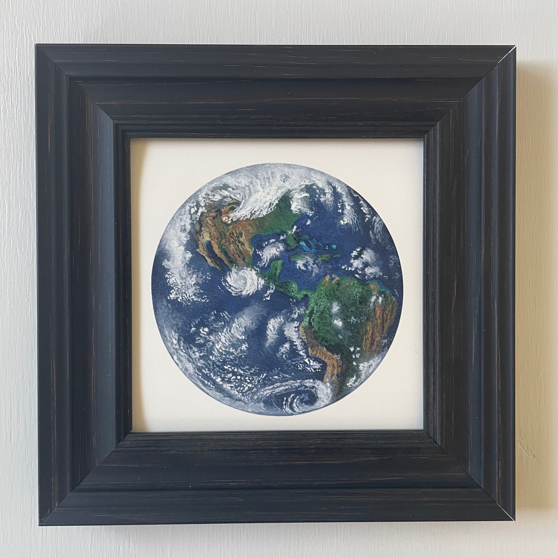 Print of Earth in black frame with white background