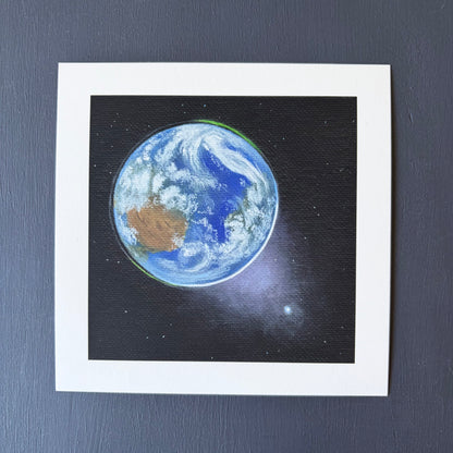 mini print of Earth from space, Venus in the bottom right, and a black background with a few stars.