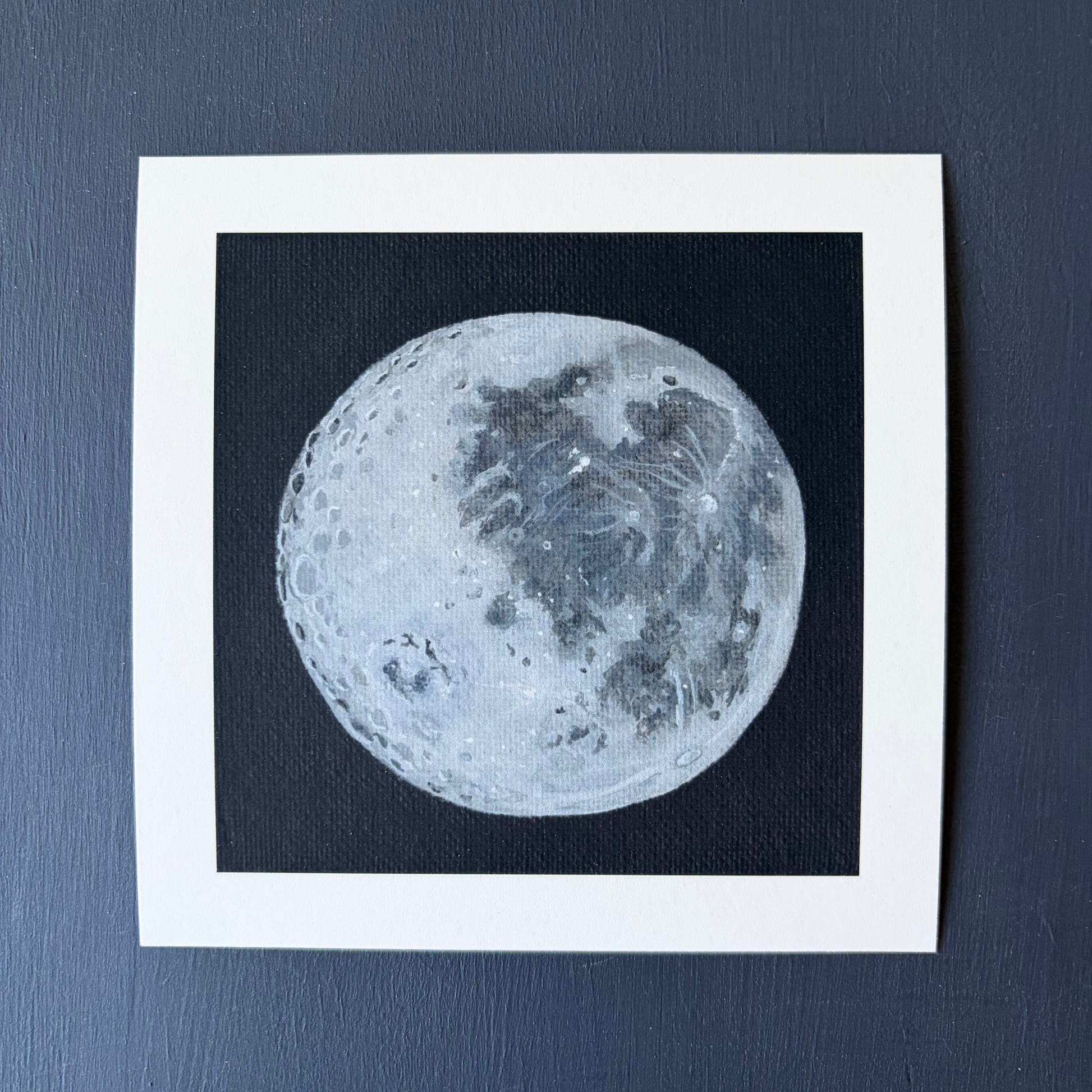 mini print of the Moon's surface on a black background