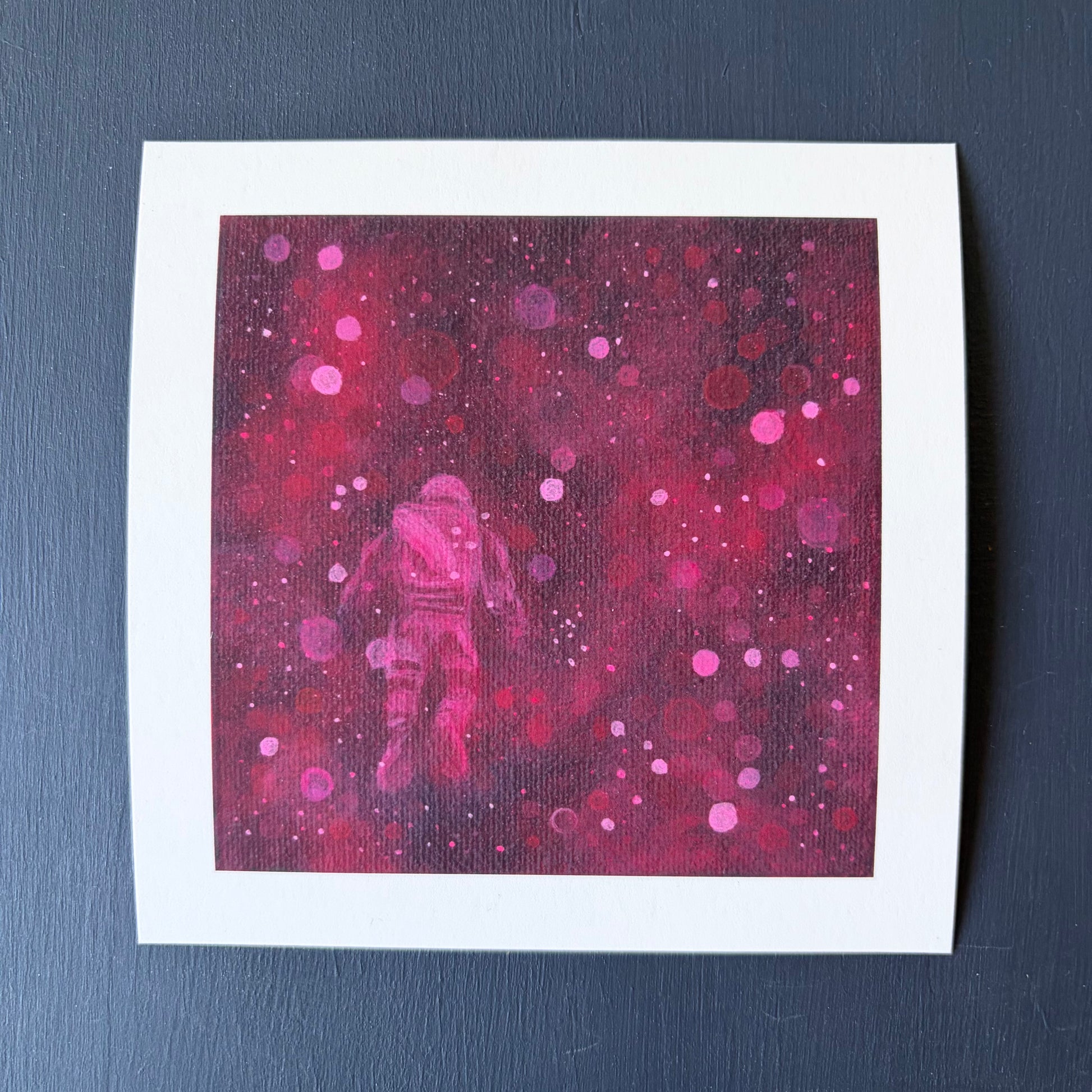 Mini print of astronaut floating surrounded by red and pink bokeh