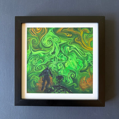 Print in black frame of swirling green and orange clouds. An astronaut floats above a spaceship at the bottom of the piece.