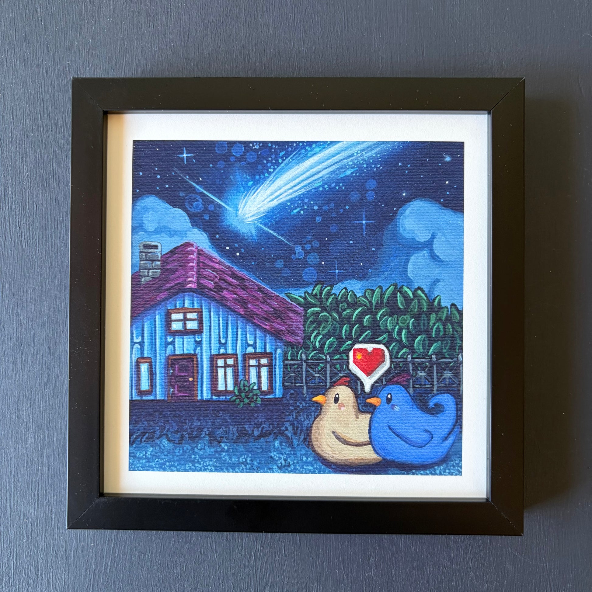 Mini print in black frame of two chickens watching a blue fireball