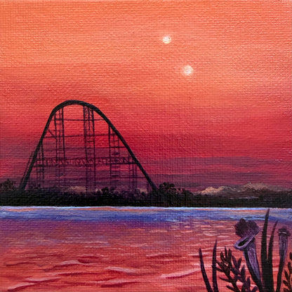 Mini painting close up. Roller coaster silhouette against a pink and orange sunset sky with water and black plants in the foreground.