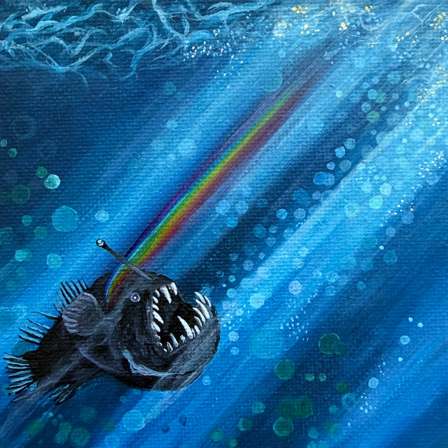 Mini painting of an anglerfish swimming to the surface with a rainbow