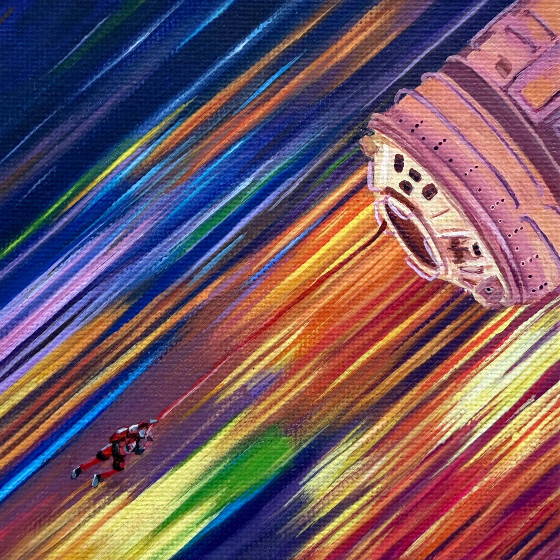 Close up of mini painting of a tiny astronaut and spaceship with a background of colorful streaks