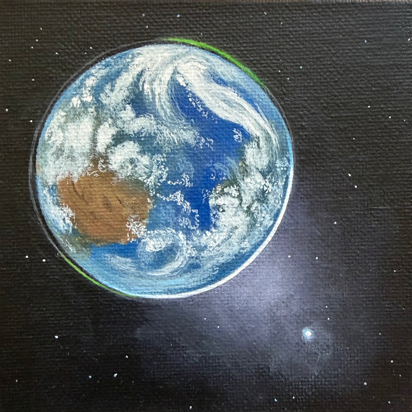 Close up of mini painting of Earth from space, Venus in the bottom right, and a black background with a few stars.