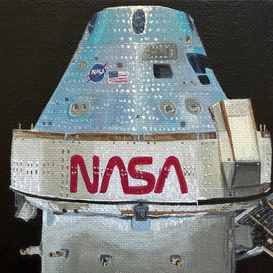 Close up of mini painting of Orion capsule  on a black background