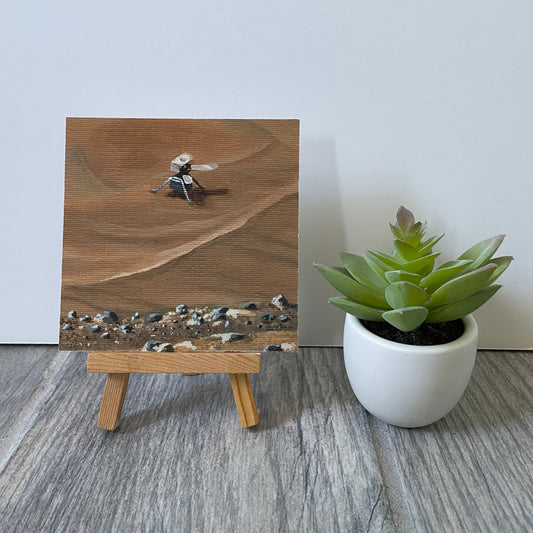 Mini print of Ingenuity painting on easel next to fake plant