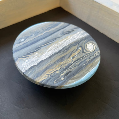 Close up of clay Jupiter floating in frame