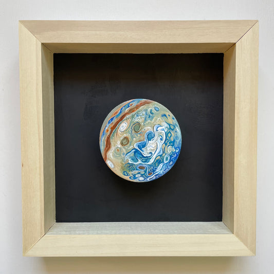 Clay disk painted like Jupiter's South Pole mounted in wood shadowbox with black background