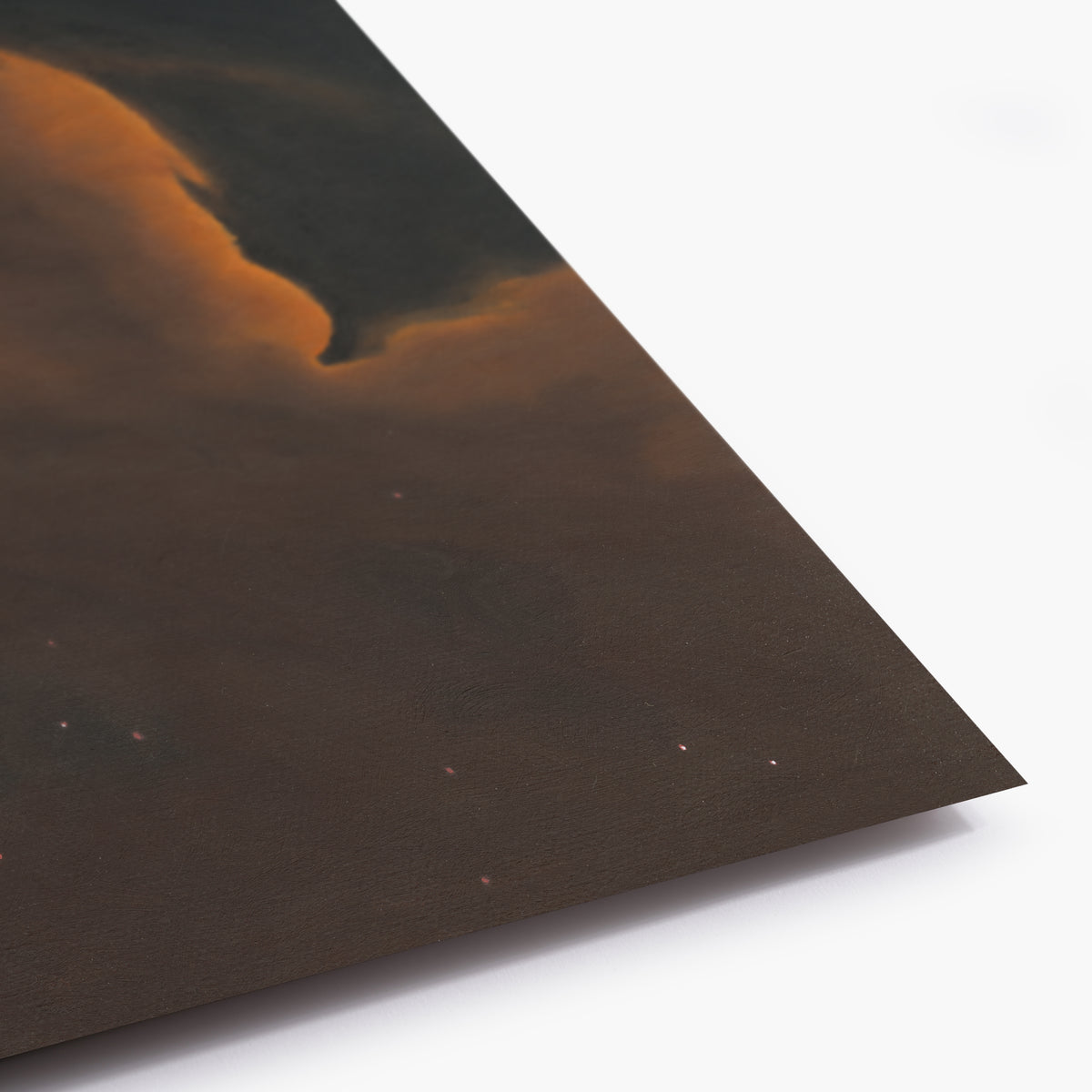 Corner of a dark brown section of the print with a textured surface on a white background