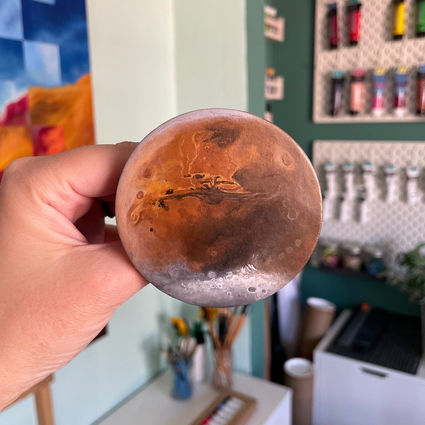 Close up view of clay painted like Mars in my left hand