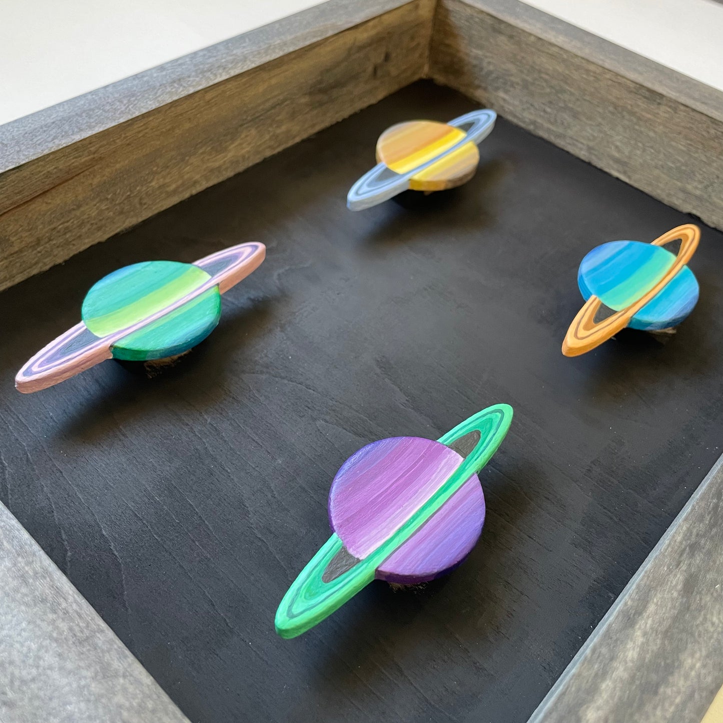 Close up of mini Saturns mounted in frame