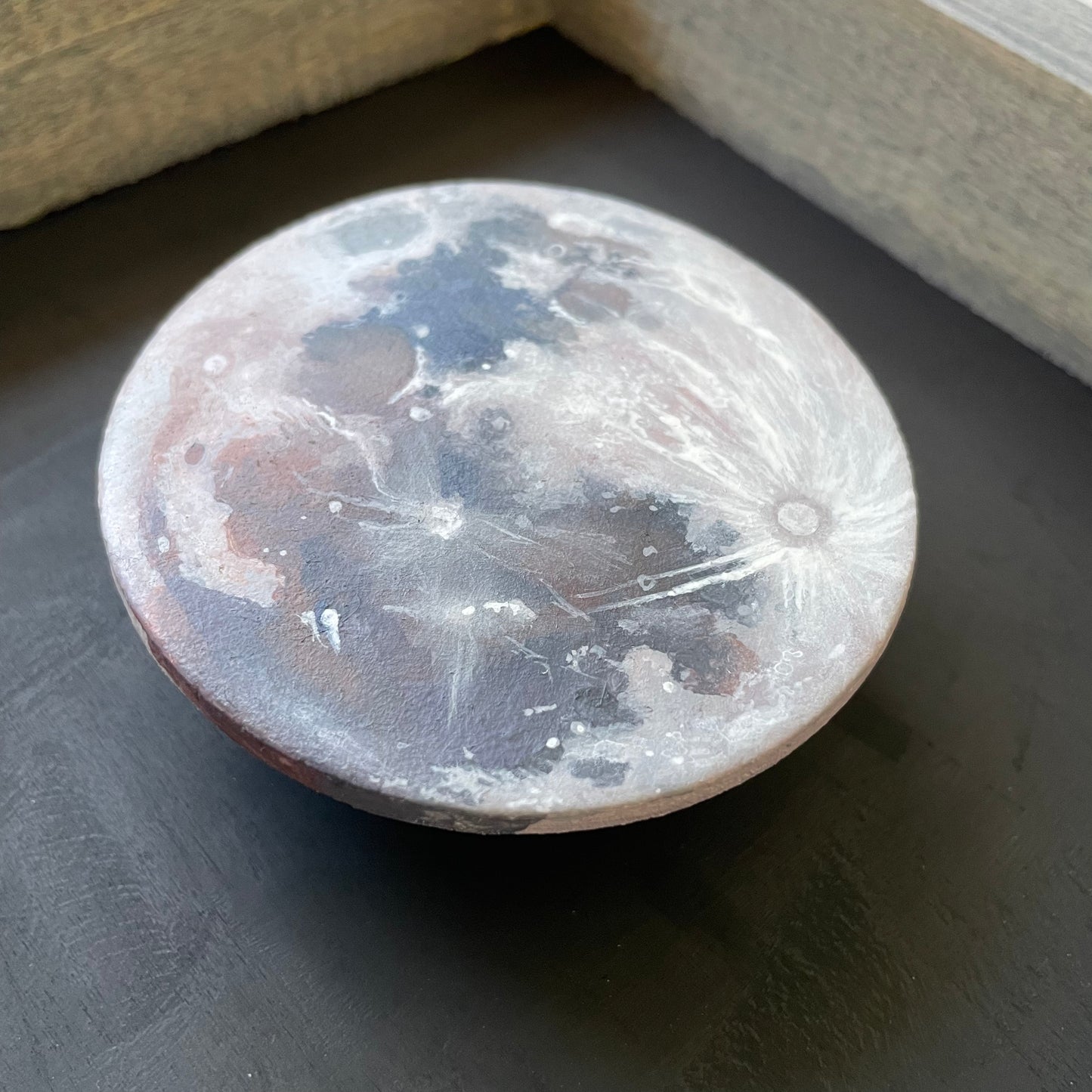 Close up of clay Moon floating in frame