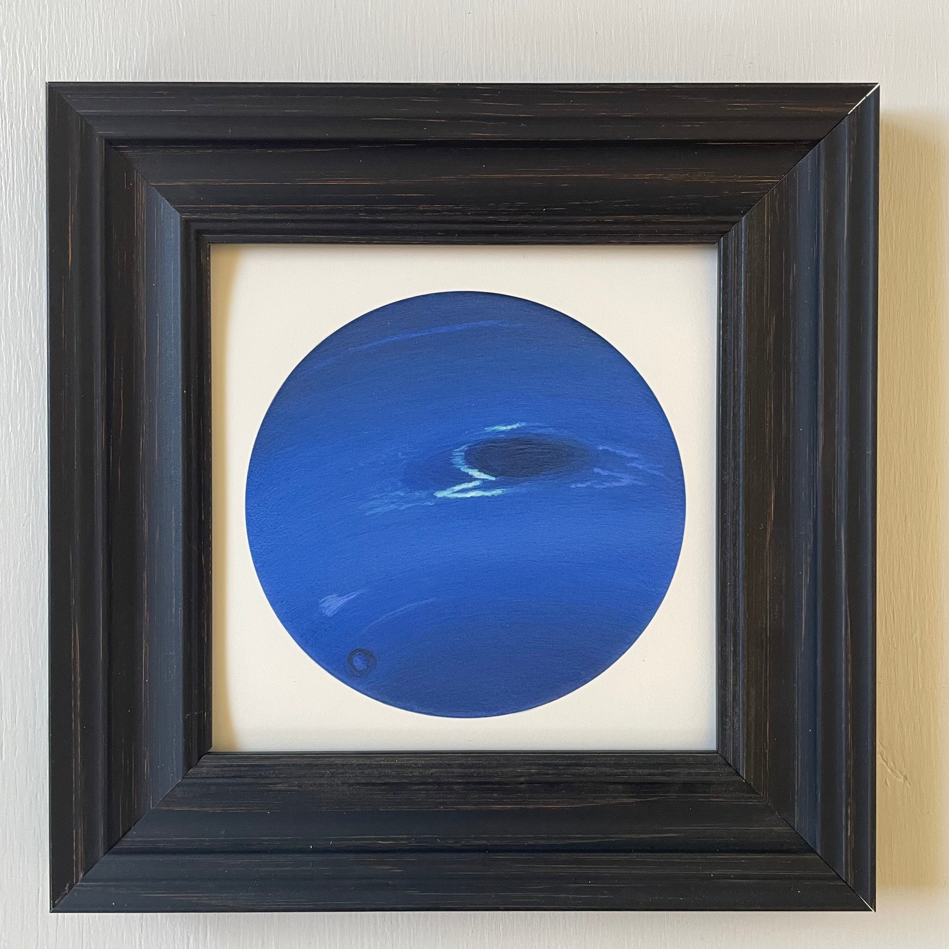 Print of Neptune in black frame with white background