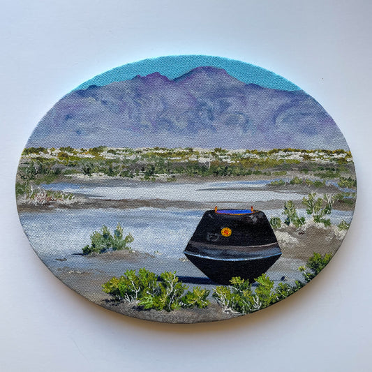 Oval painting of the sample capsule from OSIRIS-REx in the Utah desert