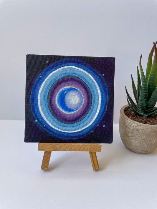 Mini painting of Uranus and its rings on small wooden easel